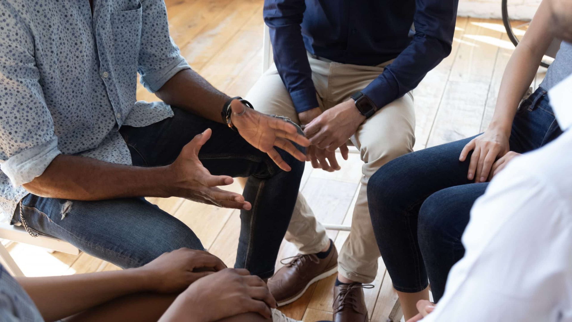 men sitting in a group talking