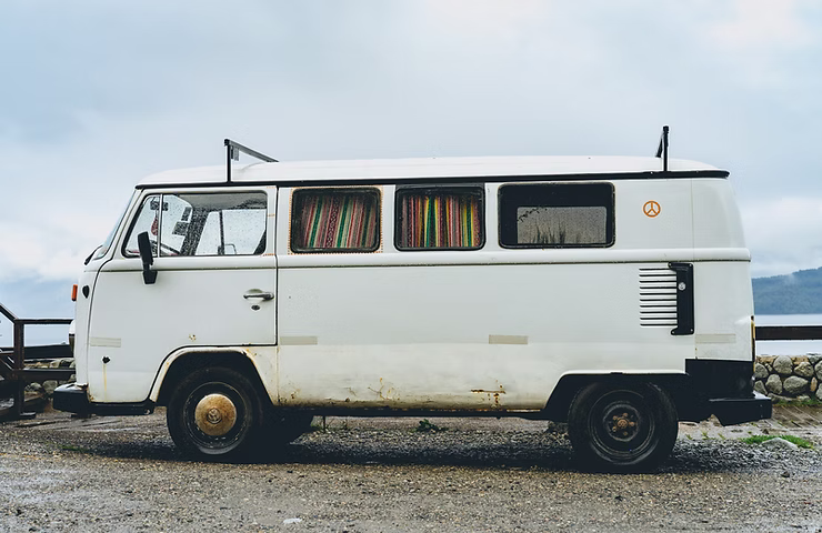 camper van sitting by the water