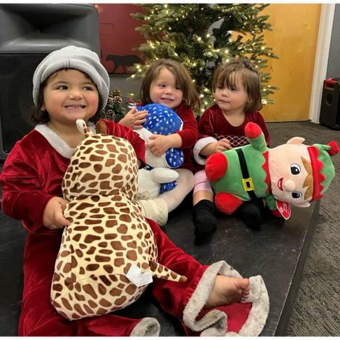 little kids playing with their new stuffed animals