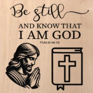 wood sign that says "be still and know that I am God. Psalm 46:10" with carvings of Jesus praying and a bible underneath
