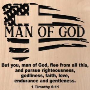 wood sign that says "man of God" in front of an american flag/cross carving. With "but you, man of God, flee from all this, and pursue righteousness, godliness, faith, love, endurance and gentleness. 1 Timothy 6:11" written beneath it.