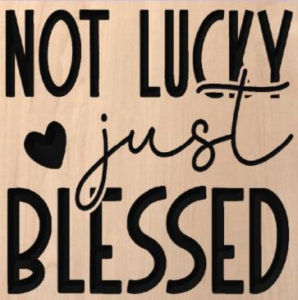 wood sign that says "Not lucky just blessed"