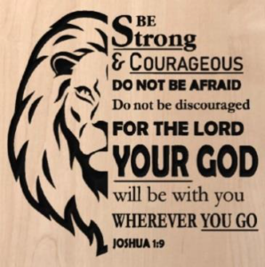 wood sign with lion head on the left side and text on the right that says "be strong & courageous do not be afraid for not be discouraged for the Lord your God will be with you wherever you go. Joshua 1:9"