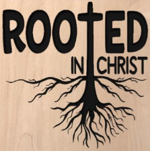 wood sign with a cross with roots and text that says "rooted in Christ"
