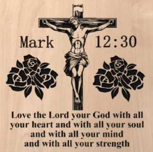 wood sign that says "mark 12:30" on the top with Jesus hanging on the cross in the middle. With roses on either side. Also says "Love the Lord your God with all your heart and with all your soul and with all your mind and with all your strength" at the bottom of the sign