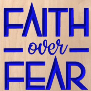 wood sign that says "faith over fear" in blue