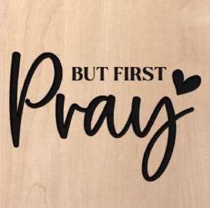 wood sign that says "but first pray"