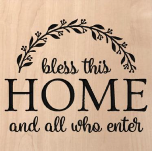 wood sign that says "bless this home and all who enter"