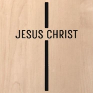 wood sign that says "Jesus Christ" in the shape of a cross