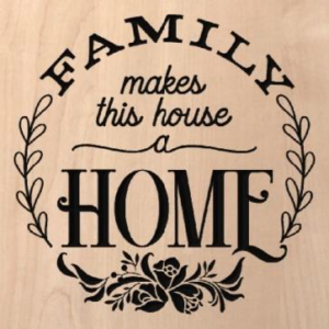 wood sign with "Family makes this house a home" written inside a vine and flower circle