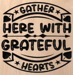 wood sign that says "gather here with grateful hearts"