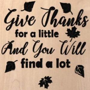 wood sign that says "give thanks for a little and you will find a lot"