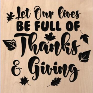 wood sign that says "let our lives be full of thanks & giving" and has leaves scattered around the words