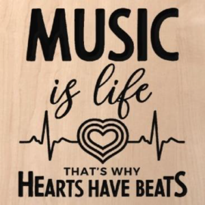 wood sign that says "music is life thats why hearts have beats" with a heart and life line carving