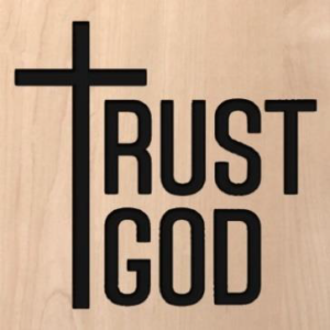 wood sign that says "trust God" with the T in trust as a cross
