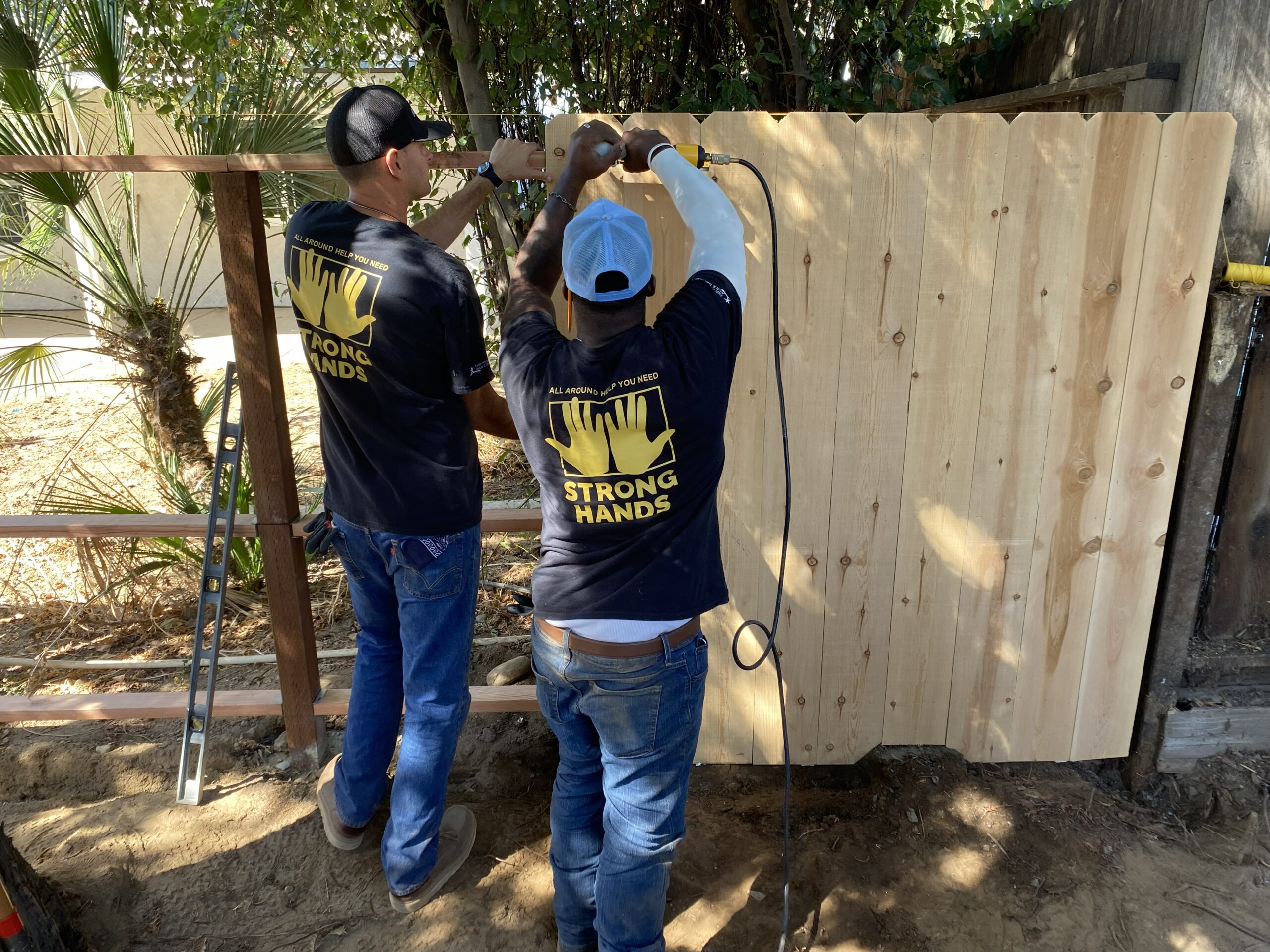 strong hands crew putting up fence